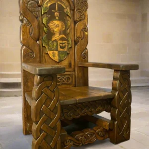 Intricately carved wooden throne with Celtic knot designs and a colorful heraldic crest on the backrest.